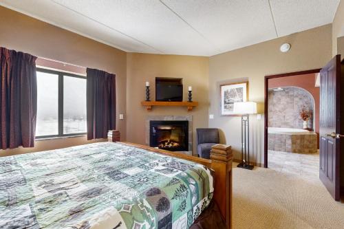 a bedroom with a bed and a fireplace at Chula Vista Condo 2632/2634 in Wisconsin Dells