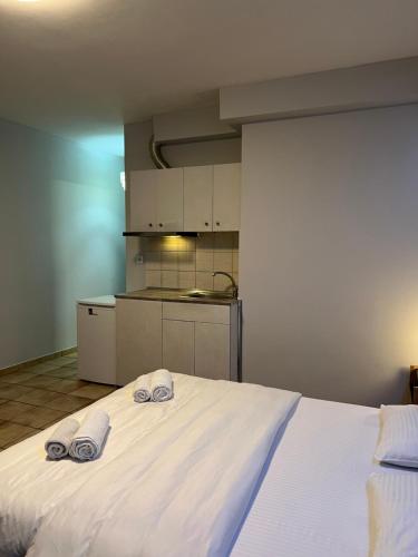 a bedroom with a bed with two towels on it at Larisa City Ap 5 with parking in Larisa
