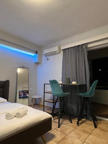 a bedroom with a bed and two chairs and a table at Larisa City Ap 5 with parking in Larisa