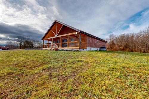 a house on top of a grassy hill at Utopian Bliss in Sevierville
