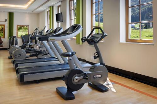 a row of exercise bikes in a gym at Arabella Jagdhof Resort am Fuschlsee, a Tribute Portfolio Hotel in Hof bei Salzburg