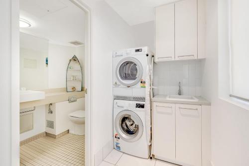 a white laundry room with a washer and dryer at Sands On Greenmount Unit 4 in Gold Coast