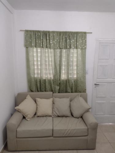 a couch in a living room with a window at Departamento in La Rioja