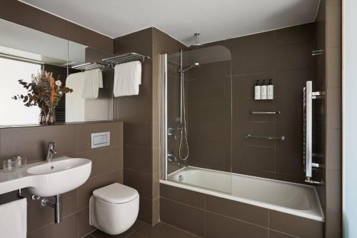 Ванная комната в voco Madrid Retiro by IHG