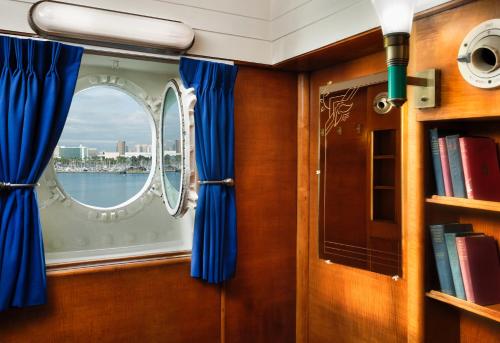 a room with a window and a book shelf at The Queen Mary in Long Beach