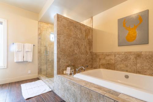 a large bathroom with a tub and a shower at Antlers on the Creek Bed & Breakfast in Durango