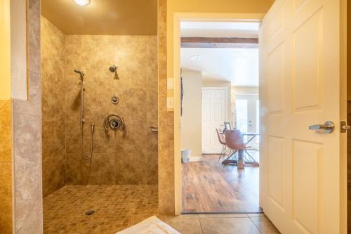 a bathroom with a shower with a glass door at Antlers on the Creek Bed & Breakfast in Durango