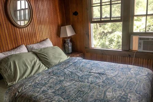 a bedroom with a bed and a window at Cherry Grove Enchantment in Cherry Grove