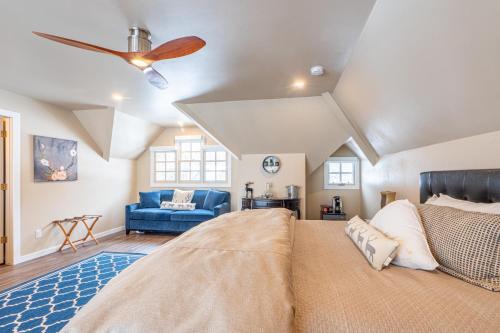 a bedroom with a large bed and a ceiling fan at Antlers on the Creek Bed & Breakfast in Durango