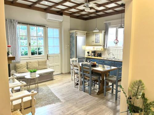 a kitchen and living room with a table and chairs at Amethyst, luxury house nearby Delphi in Kírra