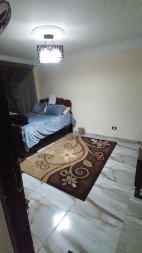 a bedroom with a bed and a rug on the floor at night holiday in in Alexandria