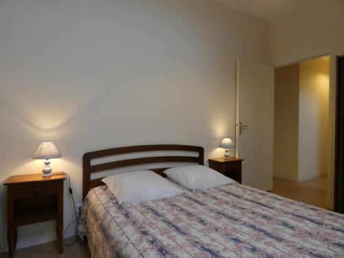 ein Schlafzimmer mit einem Bett und zwei Nachttischen mit Lampen in der Unterkunft Gîte Trizay-Coutretot-Saint-Serge, 4 pièces, 5 personnes - FR-1-581-67 in Trizay-Coutretot-Saint-Serge