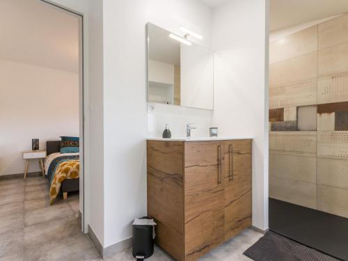 a bathroom with a vanity and a bed in a room at Maison calme, rénovée, proche Clisson – 3 chambres, terrasses, jardin, pétanque, stationnement privé - FR-1-306-1208 in Clisson