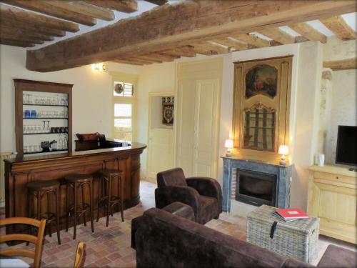 a living room with a bar and a fireplace at Gîte Montmirail, 3 pièces, 4 personnes - FR-1-410-211 in Montmirail