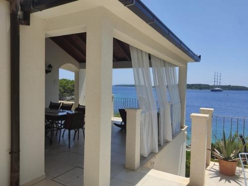 a balcony of a house with a view of the water at Seaside holiday house Cove Tri luke, Korcula - 22092 in Vela Luka
