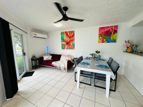 a living room with a table and a couch at Holiday at Henry St West End, Townsville QLD 3 night min in North Ward