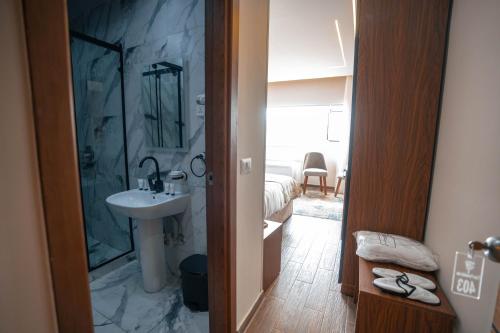 a bathroom with a sink and a shower at Tuia pyramids hotel in Cairo