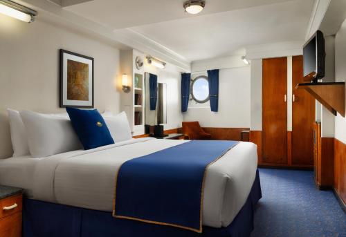 a bedroom with a large bed in a room at The Queen Mary in Long Beach