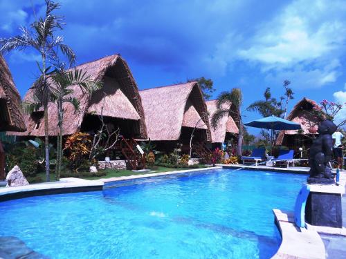 a swimming pool in front of a resort at Harta Lembongan Villas in Nusa Lembongan