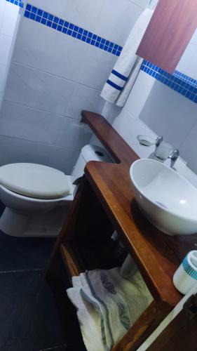 a bathroom with a sink and a toilet at Sharick Beach House in Tubará