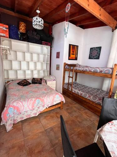 a bedroom with a bed and two bunk beds at El remanso in Mar del Plata