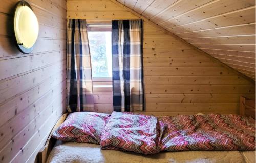 a bed in the corner of a room in a cabin at Gorgeous Home In Vikedal With Kitchen in Vikedal