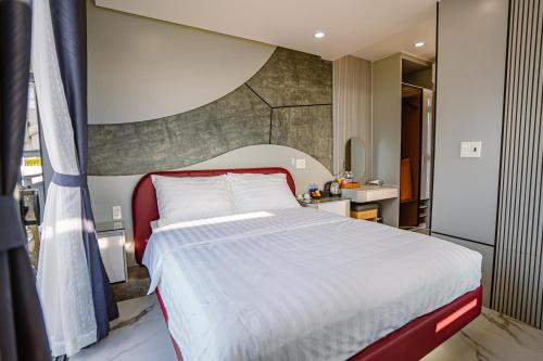 a bedroom with a large bed and a bathroom at Xuân Home in Trai Mat