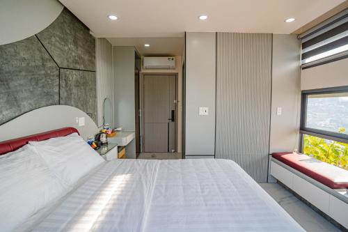 a bedroom with a large white bed and a window at Xuân Home in Trai Mat