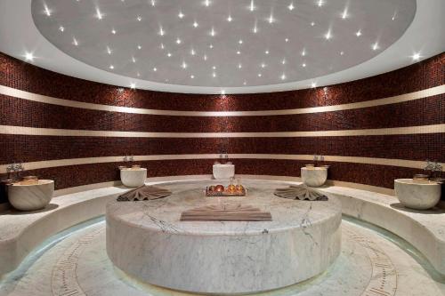 a large room with a round table in front of a flag at Le Meridien Istanbul Etiler in Istanbul