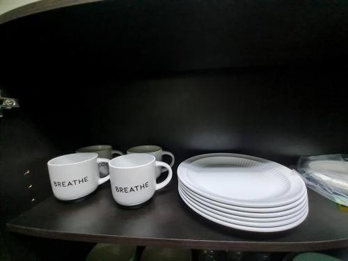 two coffee cups and plates on a table at Beach-Style Pool Villa Paradise in Río Hato