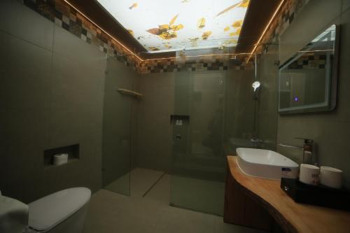 a bathroom with a toilet and a sink and a mirror at Xuân Home in Trai Mat