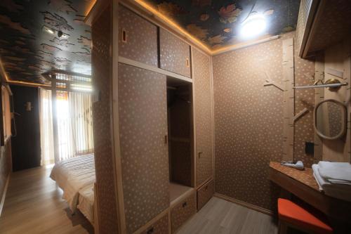 a bathroom with a walk in shower next to a bed at Xuân Home in Trai Mat