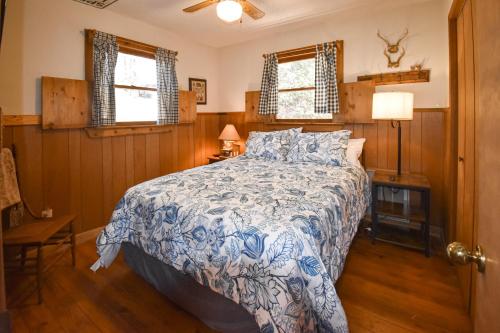 1 dormitorio con 1 cama con edredón azul y blanco en Heavenly Eden, en Hiawassee