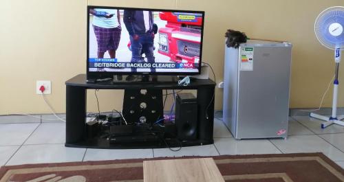 a tv sitting on a table in a room at Room Blue in Pretoria