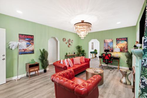 a living room with a red couch and a chandelier at NEW! Havana Nights Villa ! Walk to Calle Ocho! in Miami