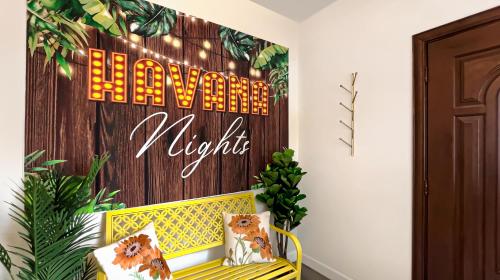 a room with a yellow bench and a sign that reads welcome to virginias at NEW! Havana Nights Villa ! Walk to Calle Ocho! in Miami