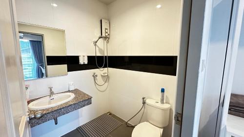 a bathroom with a toilet and a sink at AURIFLEX HOUSE in Krabi