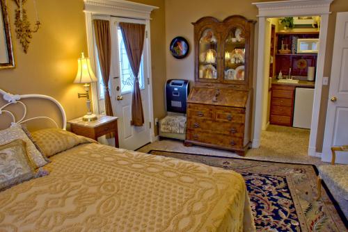 a bedroom with a large bed and a dresser and a dresser at Big Yellow Inn in Cedar City