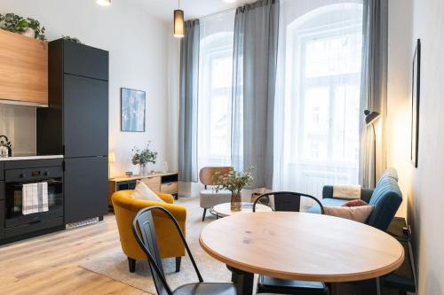 a living room with a table and chairs at Deluxe 2BDRs Home in Spa District Center in Karlovy Vary