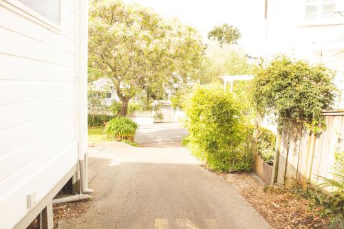 an empty street next to a white house at Hilltop on Milton in Napier