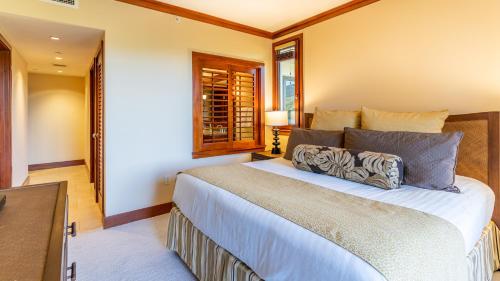 a bedroom with a large bed and a window at Ko Olina Beach Villas O401 in Kapolei