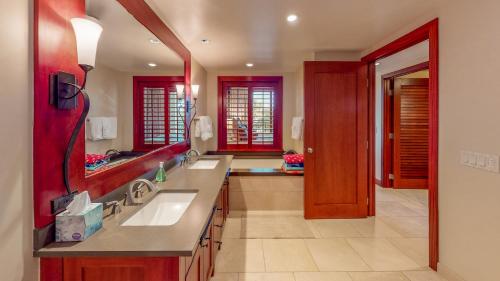a large bathroom with two sinks and a large mirror at Ko Olina Beach Villas O401 in Kapolei