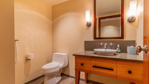 a bathroom with a toilet and a sink at Ko Olina Beach Villas O401 in Kapolei