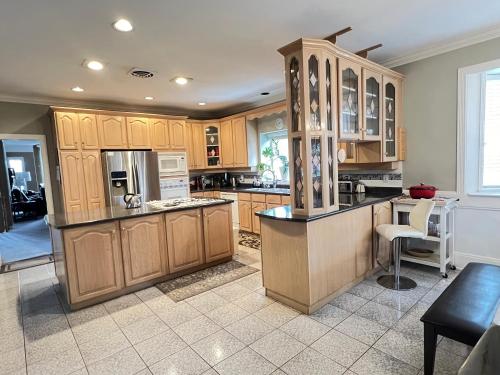 a large kitchen with wooden cabinets and a counter at V.I.P. CLUB in Surrey