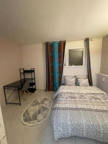 sypialnia z 2 łóżkami i biurkiem w obiekcie Appartement JO 2024 Paris Disney w mieście Villeparisis