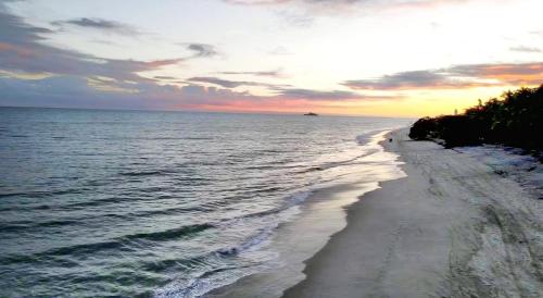 a view of the beach at sunset at Beach-Style Pool Villa Paradise in Río Hato