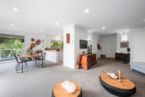 a living room with a couch and a table at Hillcrest Hideaway - Napier Holiday Apartment in Napier