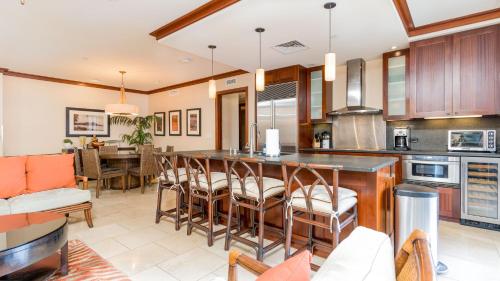 a kitchen with a bar and a dining room at Ko Olina Beach Villas O521 in Kapolei