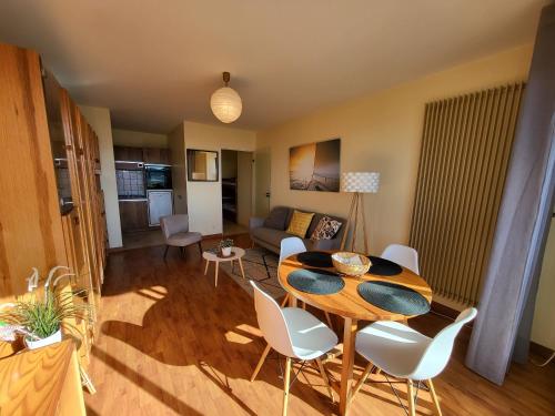 un salon avec une table et des chaises blanches dans l'établissement Studio proche plage avec parking privatif et balcon - FR-1-92-615, à Les Sables-dʼOlonne