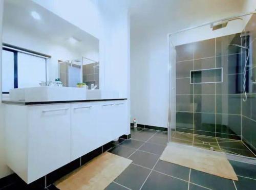 a bathroom with a shower and a sink at Mel south east huge luxury home in Keysborough